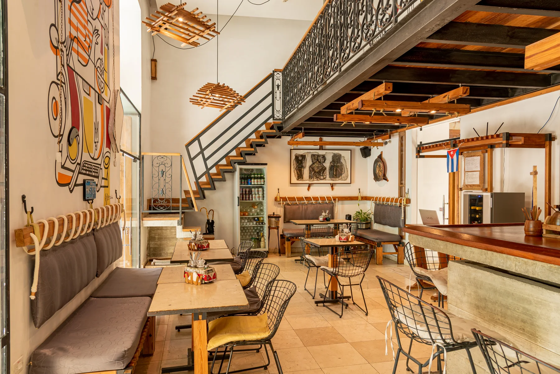 Residencia Santa Clara’s air-conditioned bar and restaurant with original murals, handcrafted furniture, and intimate seating